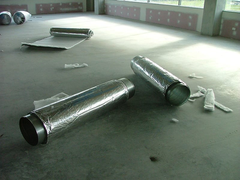 ductwork components laying on the ground in a new build home