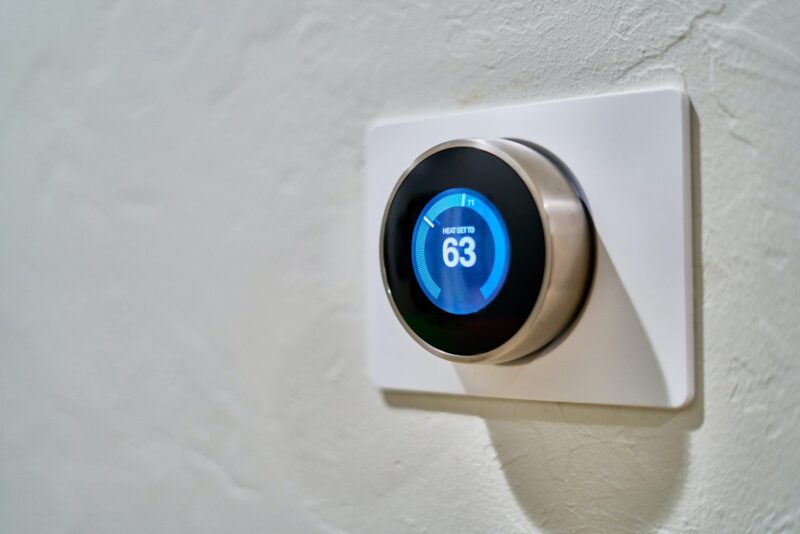 closeup of smart thermostat that's set to 63 degrees