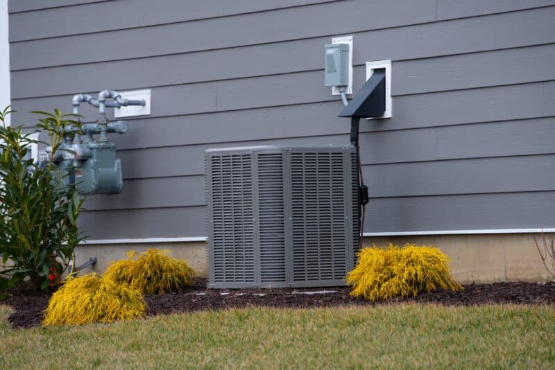 closeup of an outdoor hvac unit connected to a residential home in buda