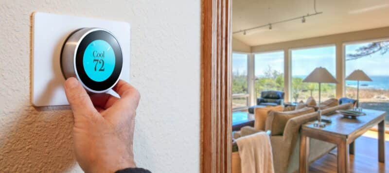 smart thermostat being adjusted